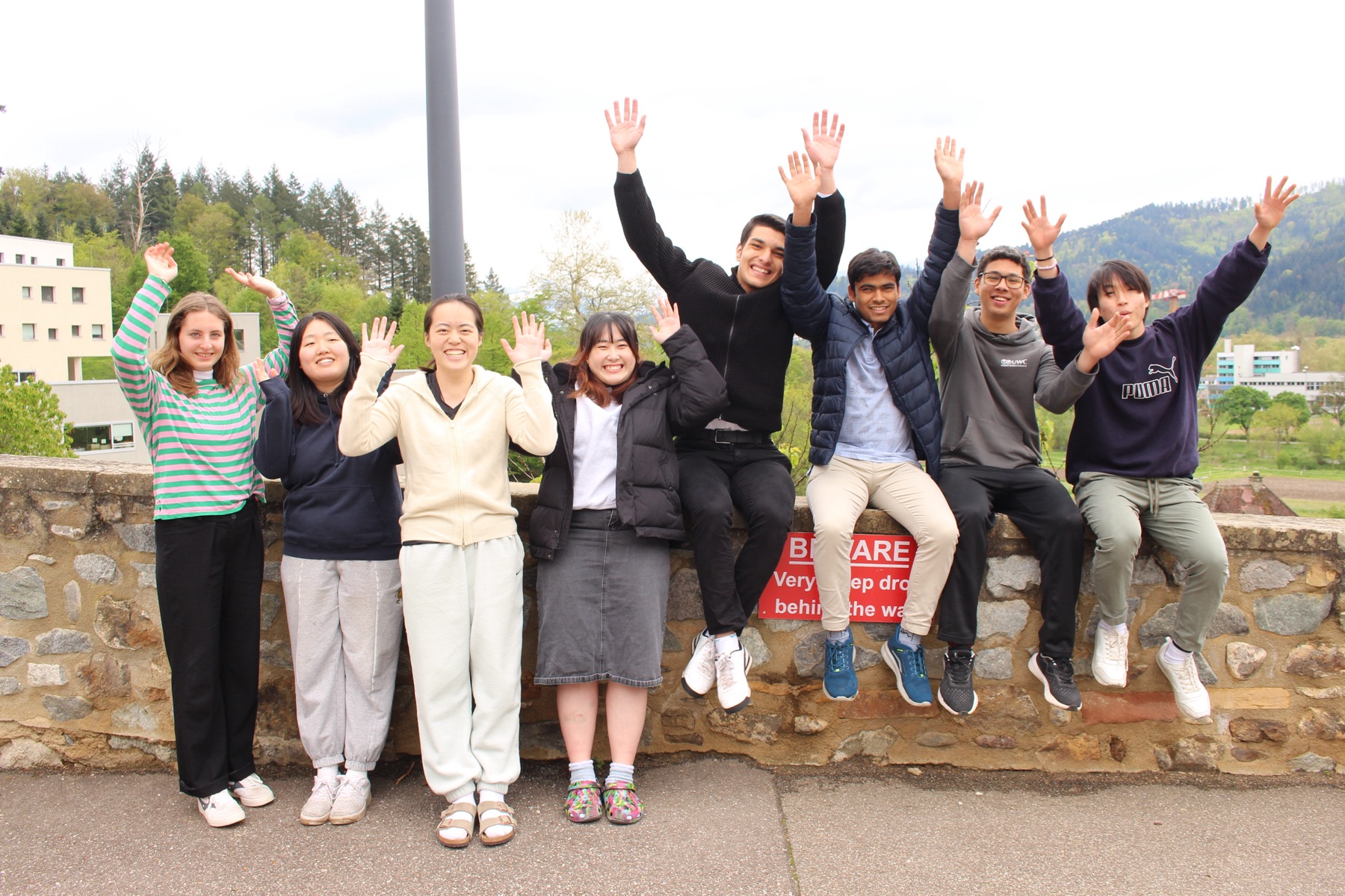 English2Success team smiling and waving together
