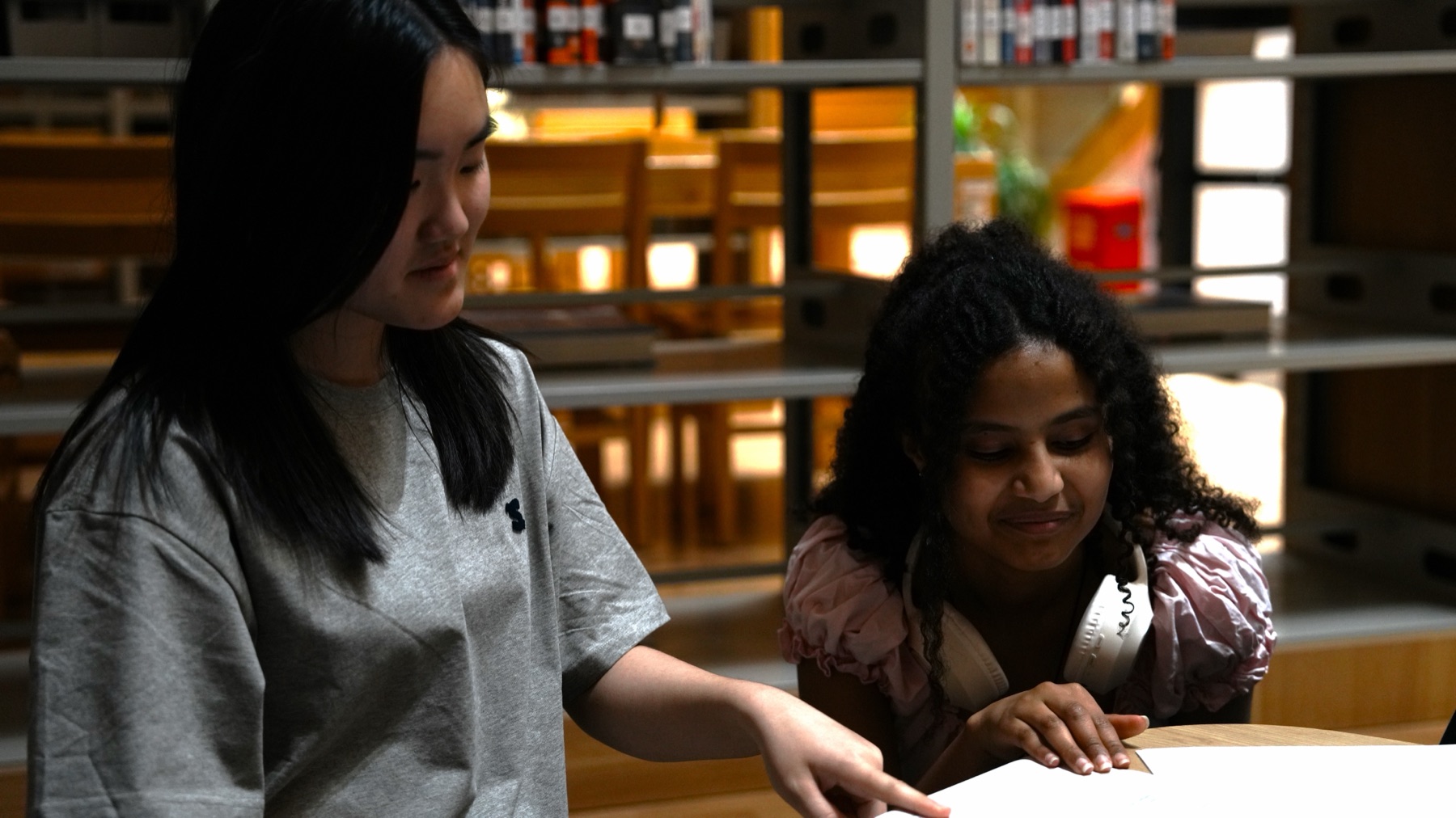 Two students working together in a library